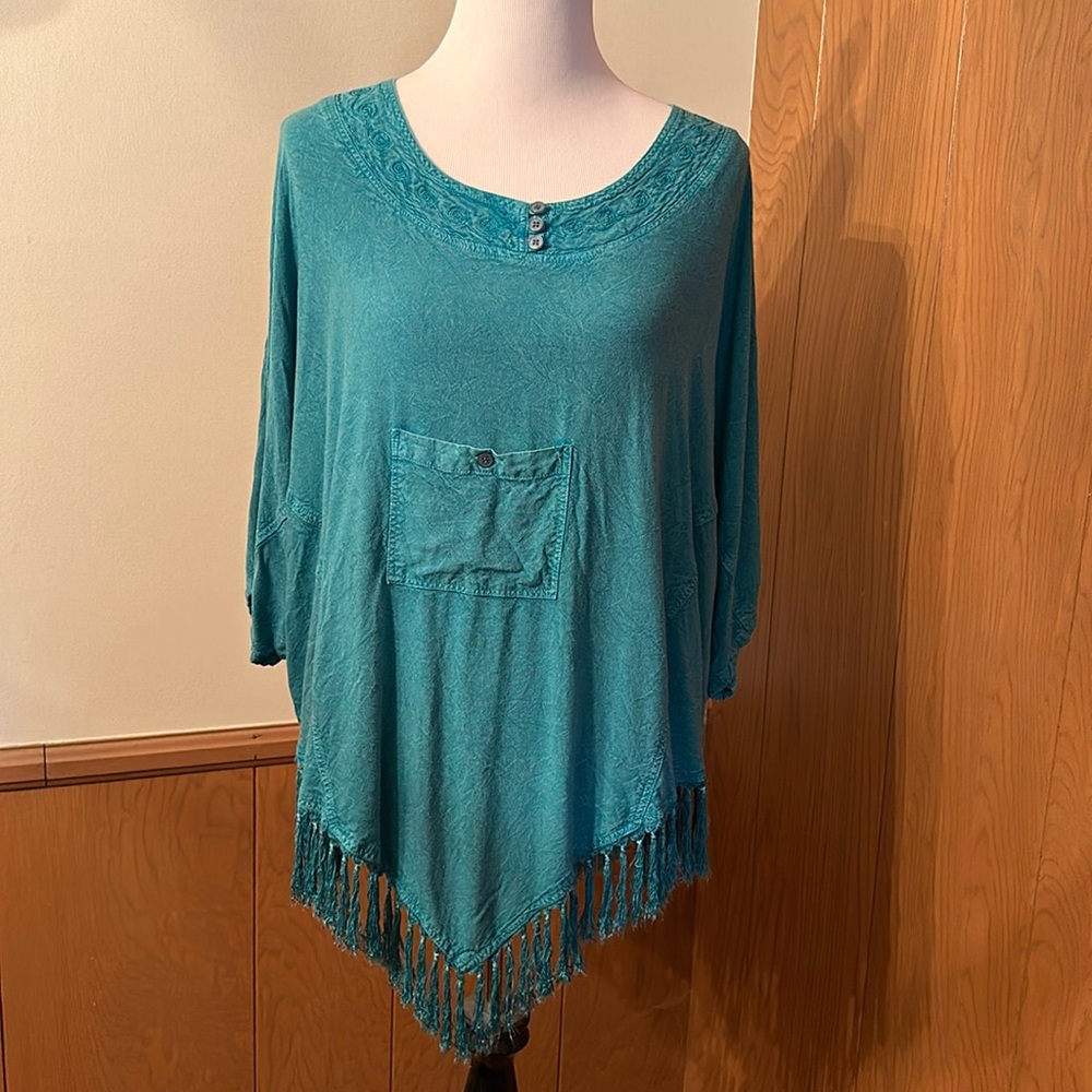 Beautiful teal poncho top with a front pocket. 100% viscose. Made in India.